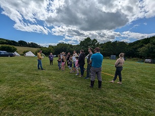 A group of people playing a Walk Through Time game at camp